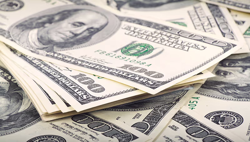 Large pile of money illustrating high-ticket coaching models, focusing on personalized, one-on-one services such as VIP coaching programs, retreats, and intensive sessions for committed clients